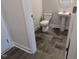 Small powder room featuring a pedestal sink, toilet, and tile flooring at 1547 Pecan Drive # 31, Nashville, NC 27856