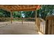 Covered back porch boasting a wooden railing and a view of the wooded surroundings at 1565 Pecan Drive # 30, Nashville, NC 27856