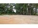 Image shows the lot of a new home with sandy soil and a treeline in the background at 1565 Pecan Drive # 30, Nashville, NC 27856