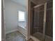 Bathroom featuring tile shower with glass door and separate tub with window at 1565 Pecan Drive # 30, Nashville, NC 27856