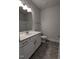 Clean bathroom with large mirror above the sink and white cabinets and a shower at 1565 Pecan Drive # 30, Nashville, NC 27856