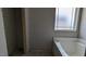 Unfinished bathroom featuring a tub with a window and a separate shower space at 1565 Pecan Drive # 30, Nashville, NC 27856