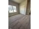 Bedroom with large window, plush carpeting and closet with double doors at 1565 Pecan Drive # 30, Nashville, NC 27856
