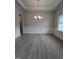 Spacious dining room features a modern chandelier and decorative wainscoting at 1565 Pecan Drive # 30, Nashville, NC 27856