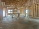 New construction framing reveals a home's open floor plan with exposed ceiling joists and ample natural light at 1565 Pecan Drive # 30, Nashville, NC 27856