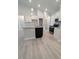 Bright kitchen featuring white cabinets, stainless appliances, and a gray granite island with modern fixtures at 1565 Pecan Drive # 30, Nashville, NC 27856