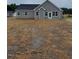 Backyard view of gray siding and a black shingled roof at 161 Jones Creek Ln, Lillington, NC 27546