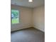 Neutral bedroom featuring wall-to-wall carpeting and a large window at 161 Jones Creek Ln, Lillington, NC 27546