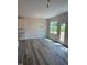 Bright dining room featuring laminate wood flooring, a modern chandelier, and windows at 161 Jones Creek Ln, Lillington, NC 27546
