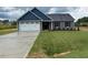 Charming single-story home featuring a two-car garage and well-maintained lawn at 161 Jones Creek Ln, Lillington, NC 27546
