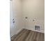 Functional laundry room with laminate wood flooring and hookups at 161 Jones Creek Ln, Lillington, NC 27546