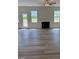 Spacious living room featuring laminate wood flooring, fireplace and three windows at 161 Jones Creek Ln, Lillington, NC 27546