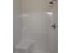 Clean shower stall featuring a built-in seat, and modern shower head at 161 Jones Creek Ln, Lillington, NC 27546