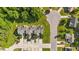 An aerial view showcases townhomes in an idyllic neighborhood with mature trees, sidewalks, and meticulously maintained lawns at 202 Wimbledon Ct, Clayton, NC 27520