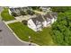 Aerial shot features well-maintained townhomes, mature trees, and sidewalks in an inviting community at 202 Wimbledon Ct, Clayton, NC 27520