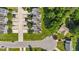 This aerial view showcases a tranquil neighborhood with well-kept lawns, trees and sidewalks at 202 Wimbledon Ct, Clayton, NC 27520