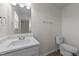 Clean bathroom offering a solid surface vanity, contemporary lighting, and neutral tones at 202 Wimbledon Ct, Clayton, NC 27520