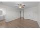 Open bedroom with a ceiling fan, wood-look floors, and an ensuite bathroom at 202 Wimbledon Ct, Clayton, NC 27520