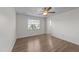 Neutral bedroom with a ceiling fan, wood-look floors, and natural light from a window at 202 Wimbledon Ct, Clayton, NC 27520