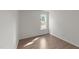 Bedroom featuring wood-look floors, a bright window, and neutral-colored walls at 202 Wimbledon Ct, Clayton, NC 27520