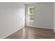 Bedroom with wood-look floors, a window, and soft, neutral wall colors at 202 Wimbledon Ct, Clayton, NC 27520