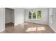 Well-lit dining room with large windows and wood-look flooring at 202 Wimbledon Ct, Clayton, NC 27520