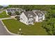 Aerial view of the back of a two-story townhome featuring a well-maintained lawn and convenient street access at 202 Wimbledon Ct, Clayton, NC 27520