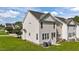 The back exterior of this home has vinyl siding, and a green lawn at 202 Wimbledon Ct, Clayton, NC 27520