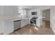 A well-lit kitchen showcasing white cabinets, stainless steel appliances, and modern countertops at 202 Wimbledon Ct, Clayton, NC 27520