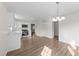 Open concept kitchen featuring white cabinets, stainless steel appliances and chandelier at 202 Wimbledon Ct, Clayton, NC 27520