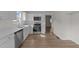 Modern kitchen boasting white cabinets, stainless appliances, and hardwood style flooring at 202 Wimbledon Ct, Clayton, NC 27520