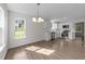 Open dining/kitchen area with white cabinets, stainless appliances, and modern flooring at 202 Wimbledon Ct, Clayton, NC 27520