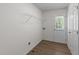 Functional laundry room with wood style flooring and access to the outside at 202 Wimbledon Ct, Clayton, NC 27520