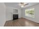 Inviting living room with a fireplace, hardwood floors, and ample natural light from a large window at 202 Wimbledon Ct, Clayton, NC 27520