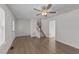 Spacious living room featuring wood flooring, stairway, ceiling fan, and natural light at 202 Wimbledon Ct, Clayton, NC 27520