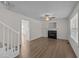 Bright living room features hardwood floors, a cozy fireplace, and an open floor plan with stairway at 202 Wimbledon Ct, Clayton, NC 27520