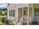 The back porch has white railings, a white door and a grilling area at 202 Wimbledon Ct, Clayton, NC 27520