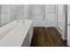A modern bathroom featuring a double vanity, bathtub, and walk in shower at 2053 Alderman Way, Creedmoor, NC 27522