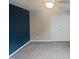 Bedroom with gray carpet, modern dark blue accent wall, and closet at 2053 Alderman Way, Creedmoor, NC 27522
