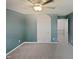 Bedroom boasts neutral carpet, ceiling fan, and doorway leading to walk-in closet at 2053 Alderman Way, Creedmoor, NC 27522