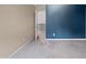 Bedroom features neutral carpet, closet, and gray-blue accent wall at 2053 Alderman Way, Creedmoor, NC 27522