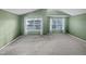 Spacious bedroom featuring two windows with natural light and neutral carpet at 2053 Alderman Way, Creedmoor, NC 27522