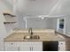 An open kitchen features granite countertops and stainless steel sink at 2053 Alderman Way, Creedmoor, NC 27522
