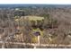 Aerial view of property surrounded by trees and a long drive leading to the house at 2053 Stillwood Dr, Youngsville, NC 27596