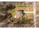 Aerial view showcasing the house, surrounding yard, driveway, and the home's outdoor living space at 2053 Stillwood Dr, Youngsville, NC 27596