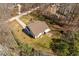Aerial view of a backyard featuring a patio, small shed, and a home with a brown roof at 2053 Stillwood Dr, Youngsville, NC 27596