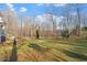 Expansive backyard with shade trees and lush green lawn perfect for outdoor activities at 2053 Stillwood Dr, Youngsville, NC 27596