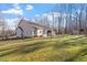 Large backyard with shade trees, screened porch, and patio area ideal for relaxing and entertaining at 2053 Stillwood Dr, Youngsville, NC 27596
