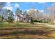 Spacious backyard with large trees and landscaped lawn perfect for outdoor activities at 2053 Stillwood Dr, Youngsville, NC 27596