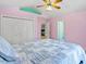 Bright bedroom with light pink walls, white closets and view to another bedroom at 2053 Stillwood Dr, Youngsville, NC 27596